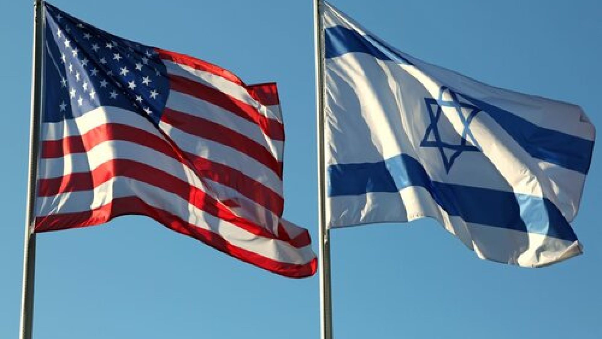 two flags: American and Israeli waving in the blue sky